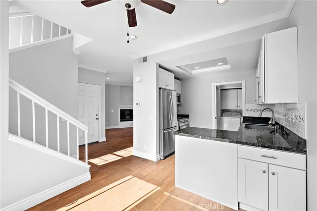 a kitchen with sink refrigerator and cabinets