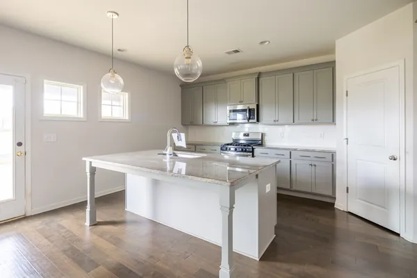 a kitchen with a sink cabinets and window