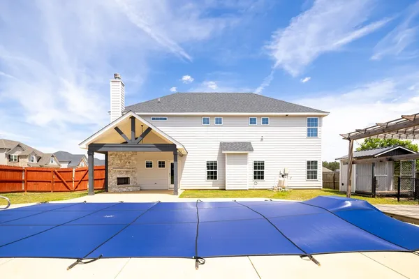 a view of a house with swimming pool and porch