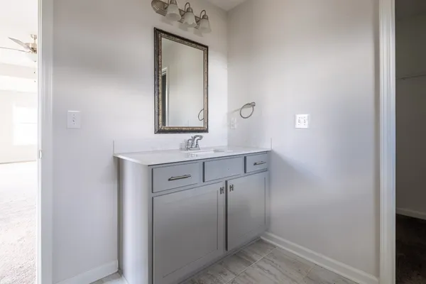 a bathroom with a sink mirror and vanity