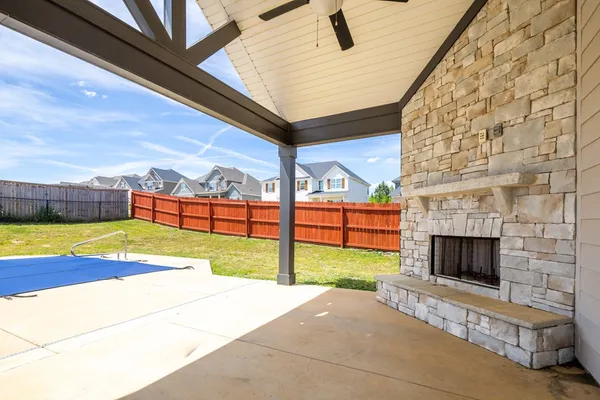 a view of swimming pool with seating area in front of the house