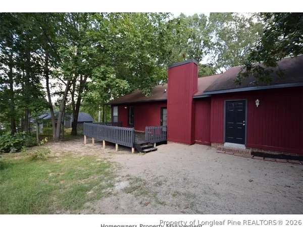 a backyard of a house with table and chairs