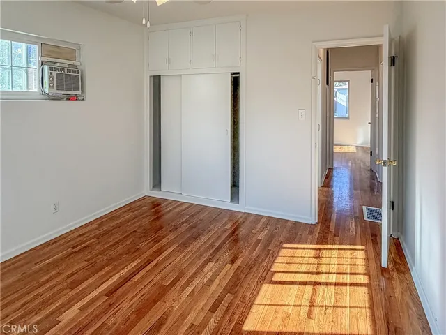 a view of a room with wooden floor and bathroom