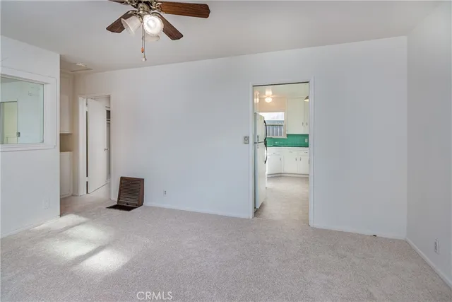 an empty room with a empty space and chandelier fan