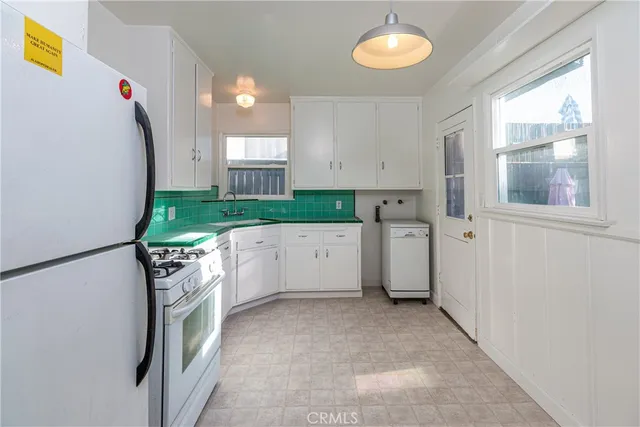 a view of a kitchen with appliances and cabinets