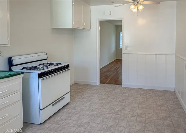 a kitchen with granite countertop cabinets a stove and a microwave