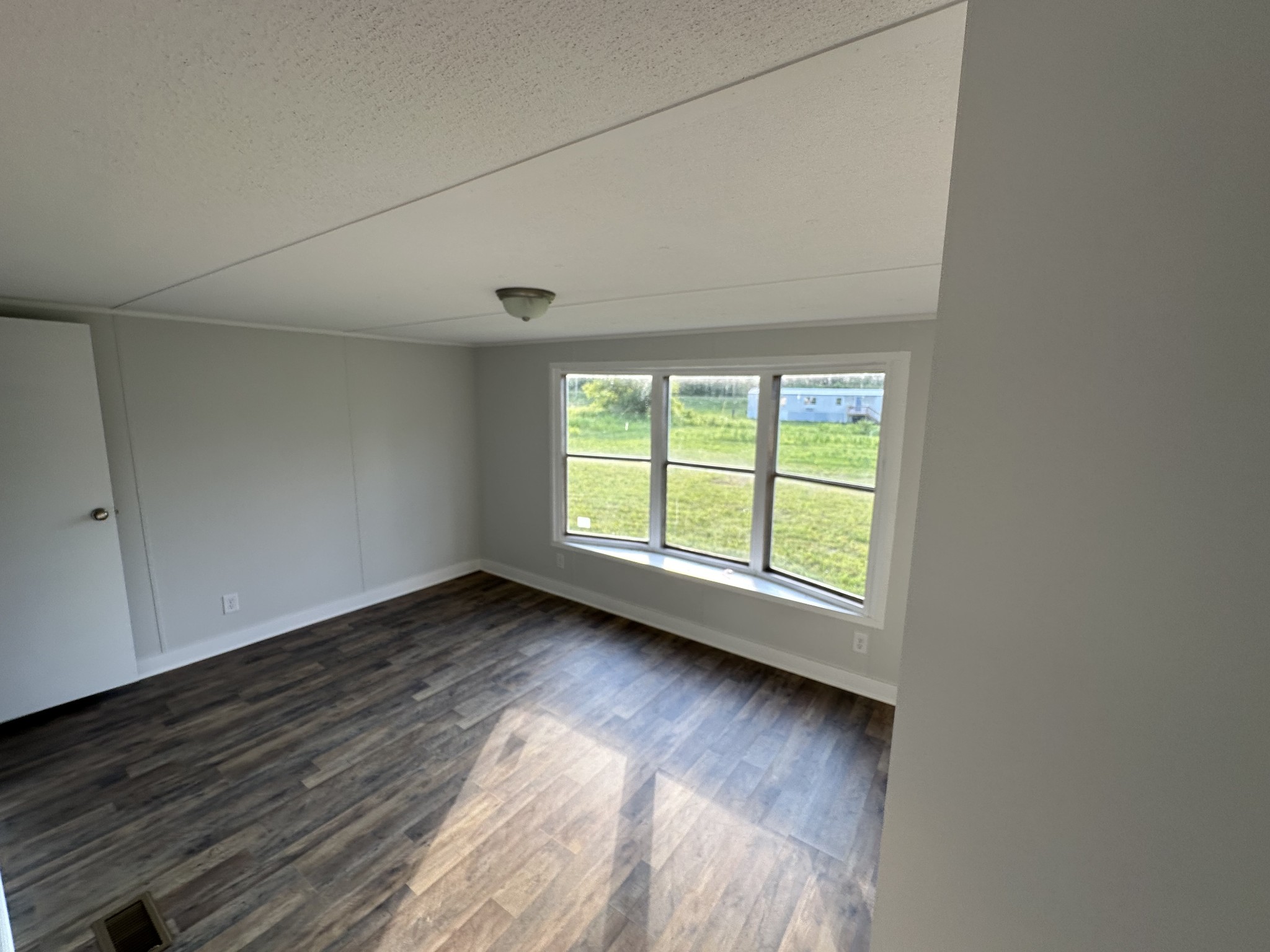 12 Young Road Buffalo Valley, TN 38548 - Photo 4 of 12 an empty room with wooden floor and windows