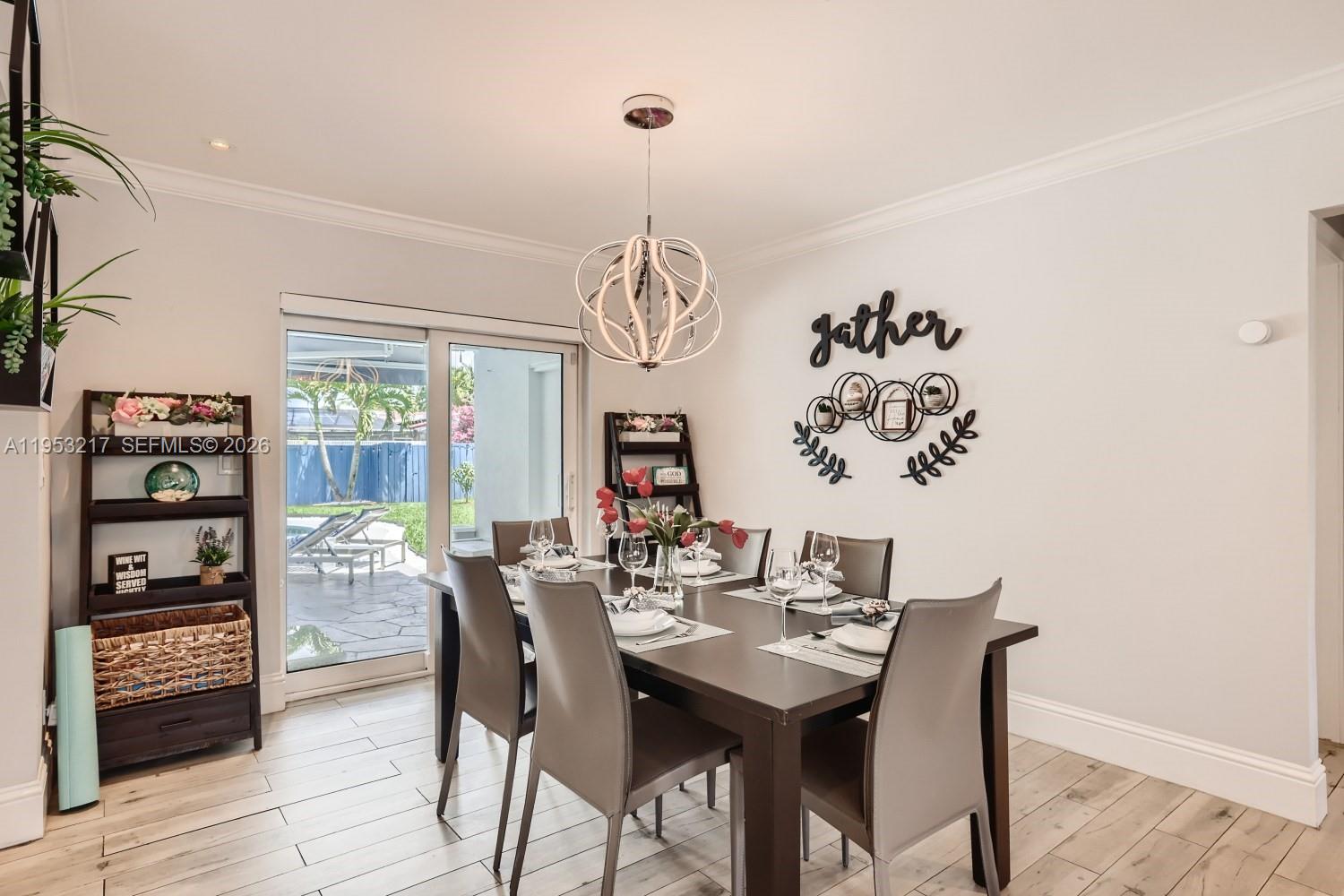 5117 Cleveland Street Hollywood, FL 33021 - Photo 11 of 39 a view of a dining room with furniture window and wooden floor
