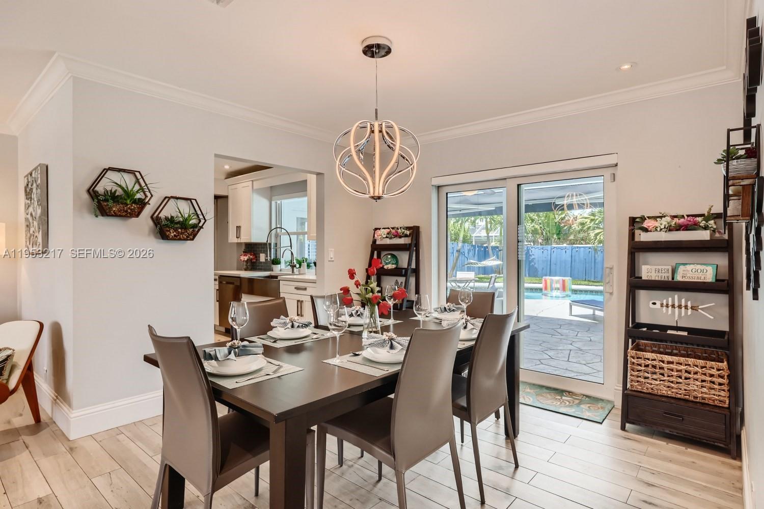 5117 Cleveland Street Hollywood, FL 33021 - Photo 13 of 39 a view of a dining room with furniture window and wooden floor