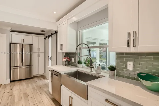 a kitchen with granite countertop a stove and a refrigerator