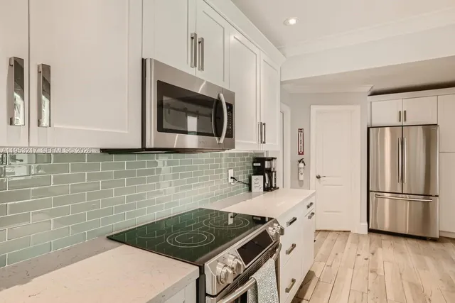 a kitchen with a sink stove and cabinets
