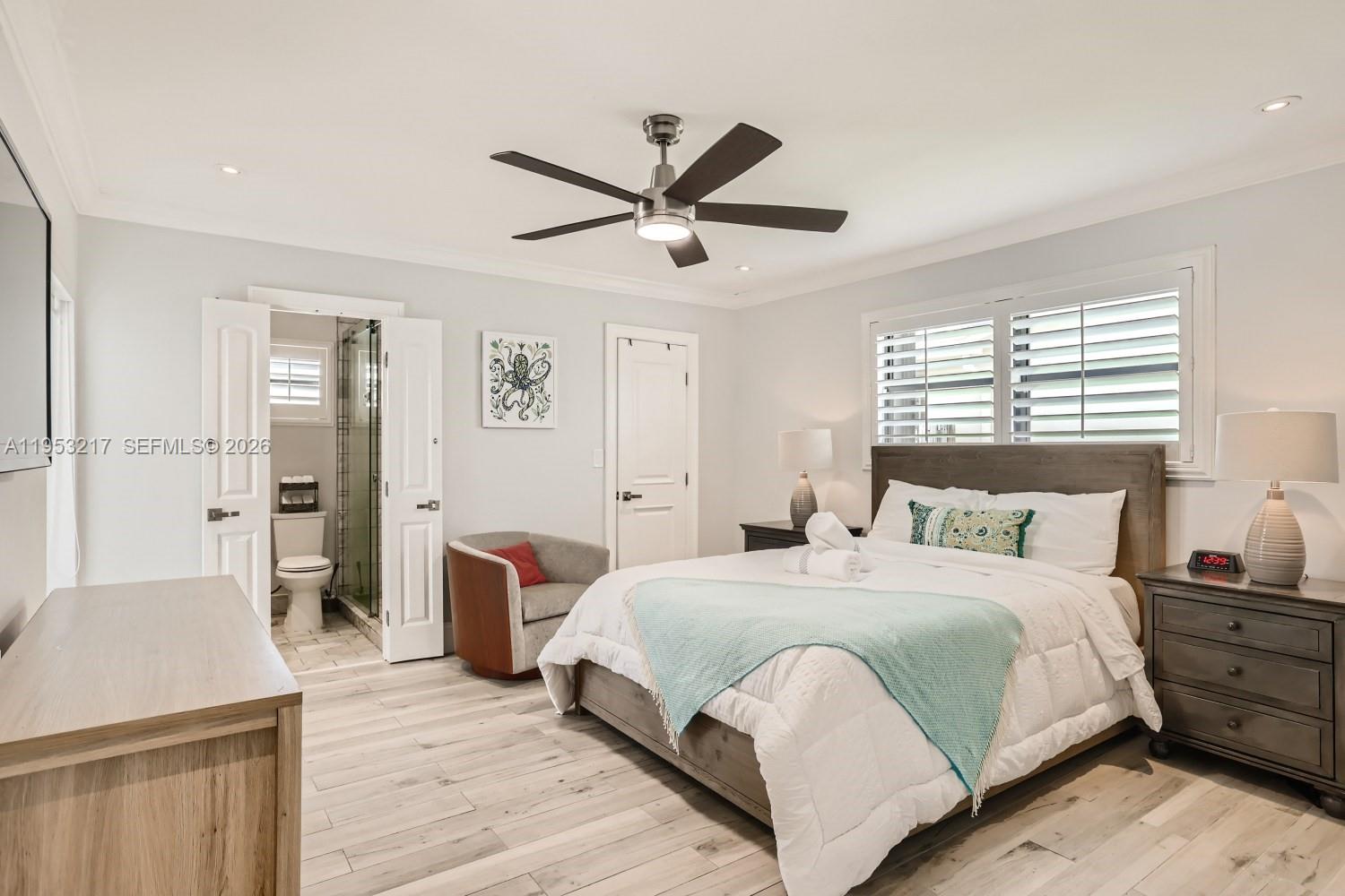 5117 Cleveland Street Hollywood, FL 33021 - Photo 19 of 39 a bedroom with a bed and wooden floor