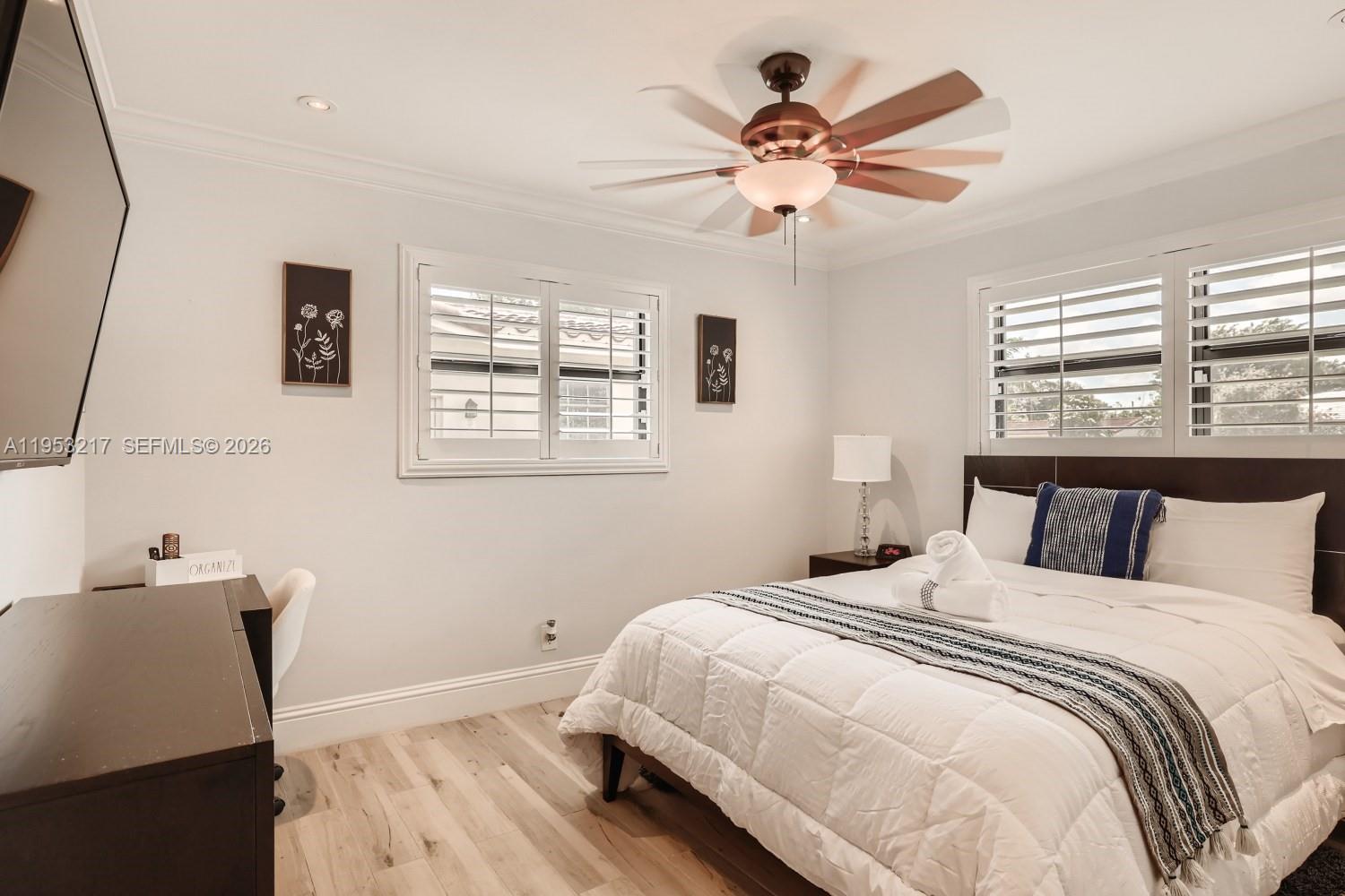 5117 Cleveland Street Hollywood, FL 33021 - Photo 21 of 39 a bedroom with a bed and a desk