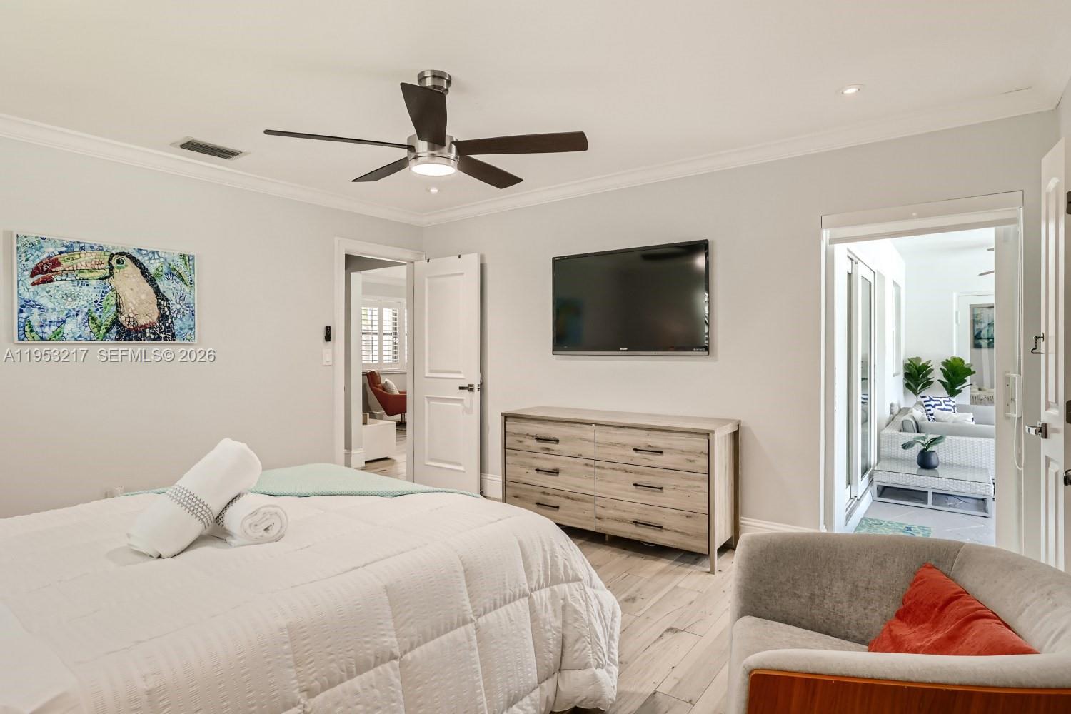 5117 Cleveland Street Hollywood, FL 33021 - Photo 23 of 39 a bedroom with furniture and a flat screen tv