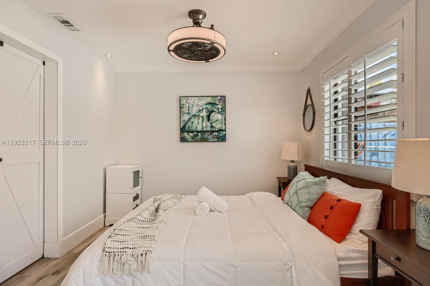 5117 Cleveland Street Hollywood, FL 33021 - Photo 29 of 39 a bedroom with a bed and a window