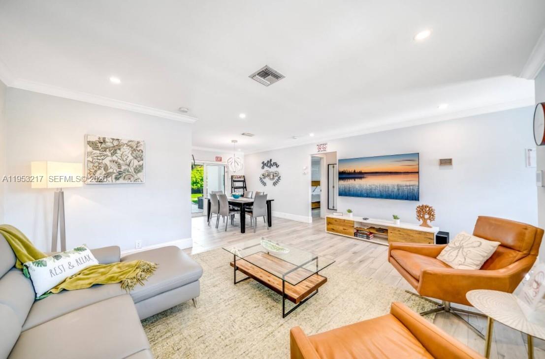 5117 Cleveland Street Hollywood, FL 33021 - Photo 6 of 39 a living room with furniture and a flat screen tv