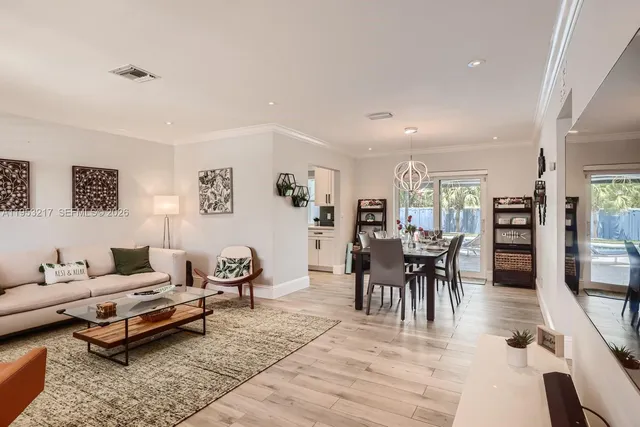 a living room with furniture a rug and a flat screen tv
