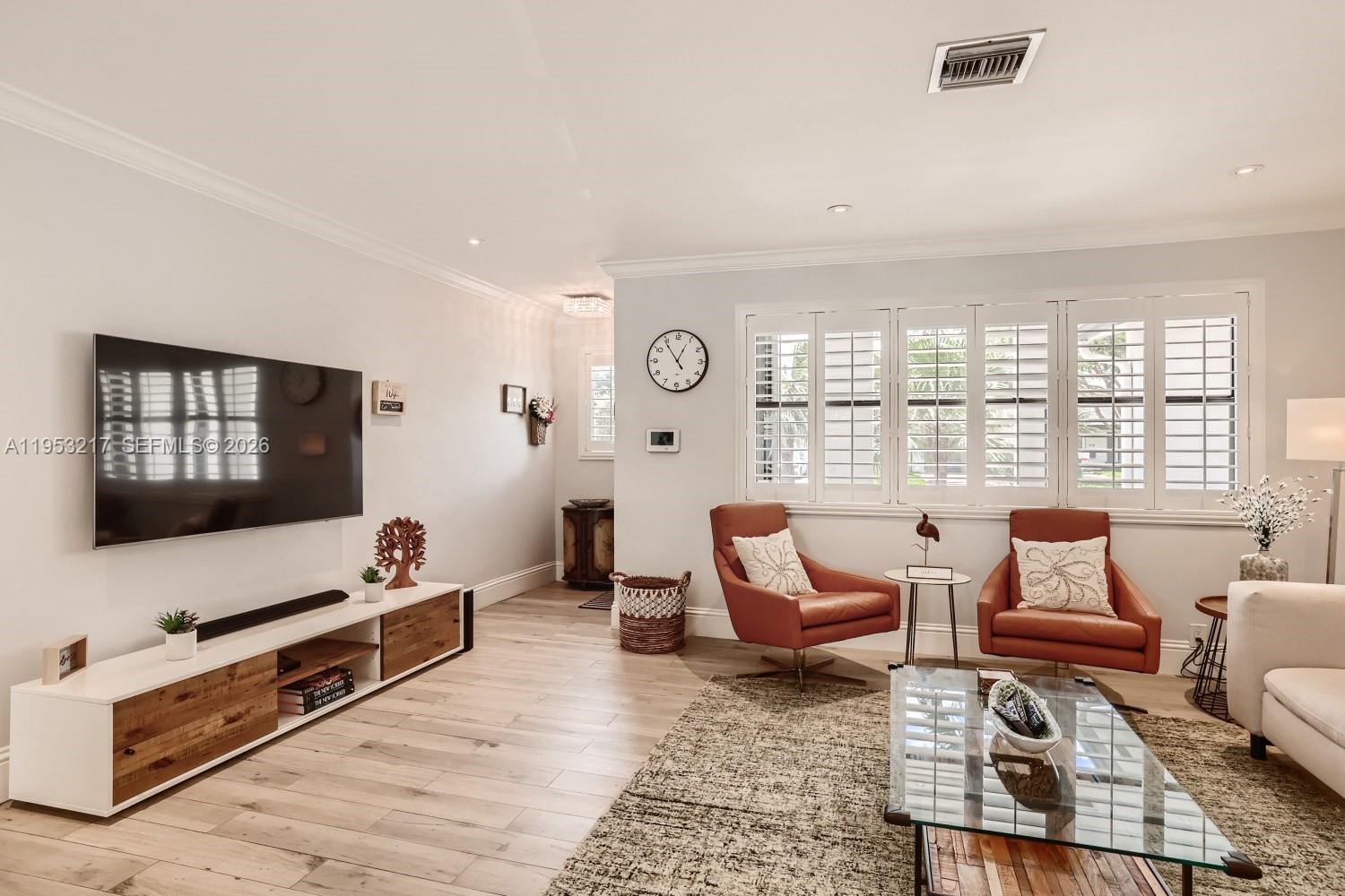 5117 Cleveland Street Hollywood, FL 33021 - Photo 8 of 39 a living room with furniture a rug and a flat screen tv