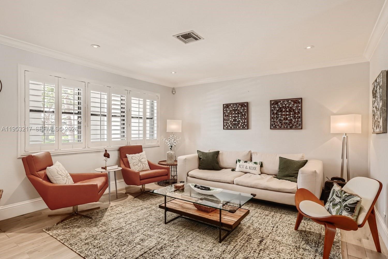 5117 Cleveland Street Hollywood, FL 33021 - Photo 9 of 39 a living room with furniture a rug and a lamp