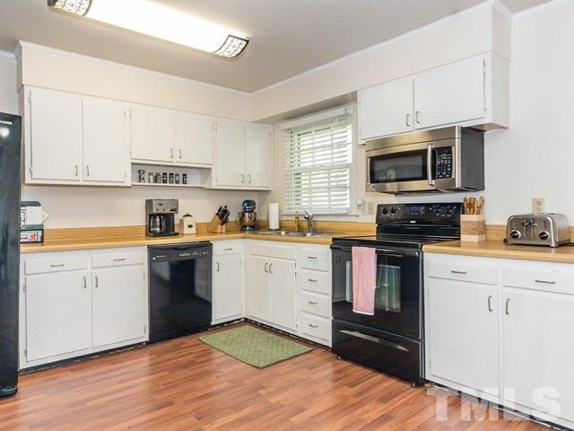 1726 Euclid Road Durham, NC 27713 - Photo 11 of 25 a kitchen with cabinets stainless steel appliances and a window