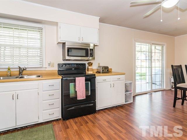 1726 Euclid Road Durham, NC 27713 - Photo 12 of 25 a kitchen with stainless steel appliances a stove sink and microwave