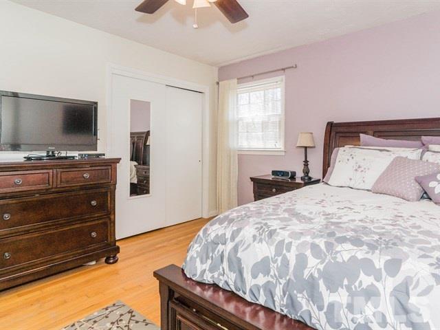 1726 Euclid Road Durham, NC 27713 - Photo 13 of 25 a bedroom with a bed and a flat screen tv