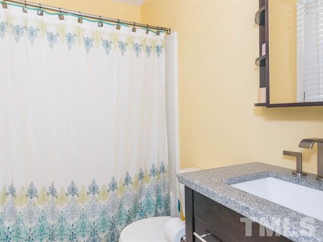 1726 Euclid Road Durham, NC 27713 - Photo 15 of 25 a bathroom with a granite countertop sink and a mirror