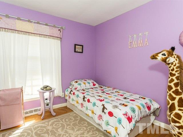 1726 Euclid Road Durham, NC 27713 - Photo 18 of 25 a bedroom with a bed and a chair