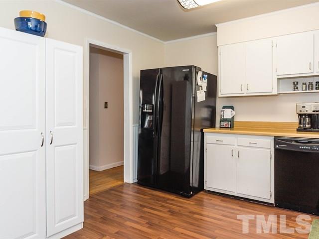 1726 Euclid Road Durham, NC 27713 - Photo 9 of 25 a kitchen with a refrigerator and cabinets
