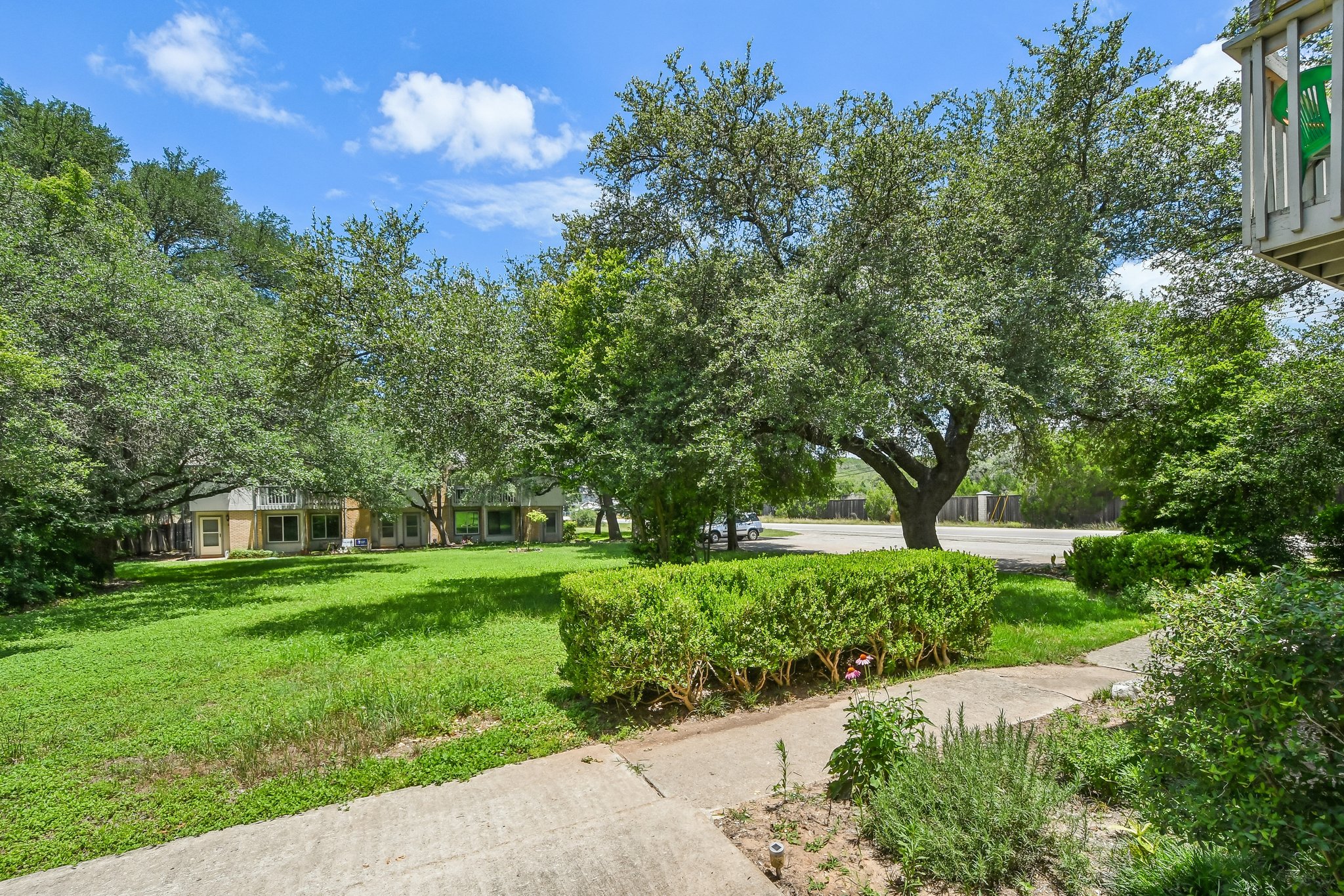 4202 Hudson Bend Road, Unit B Austin, TX 78734 - Photo 2 of 26 a view of a garden with a building in the background