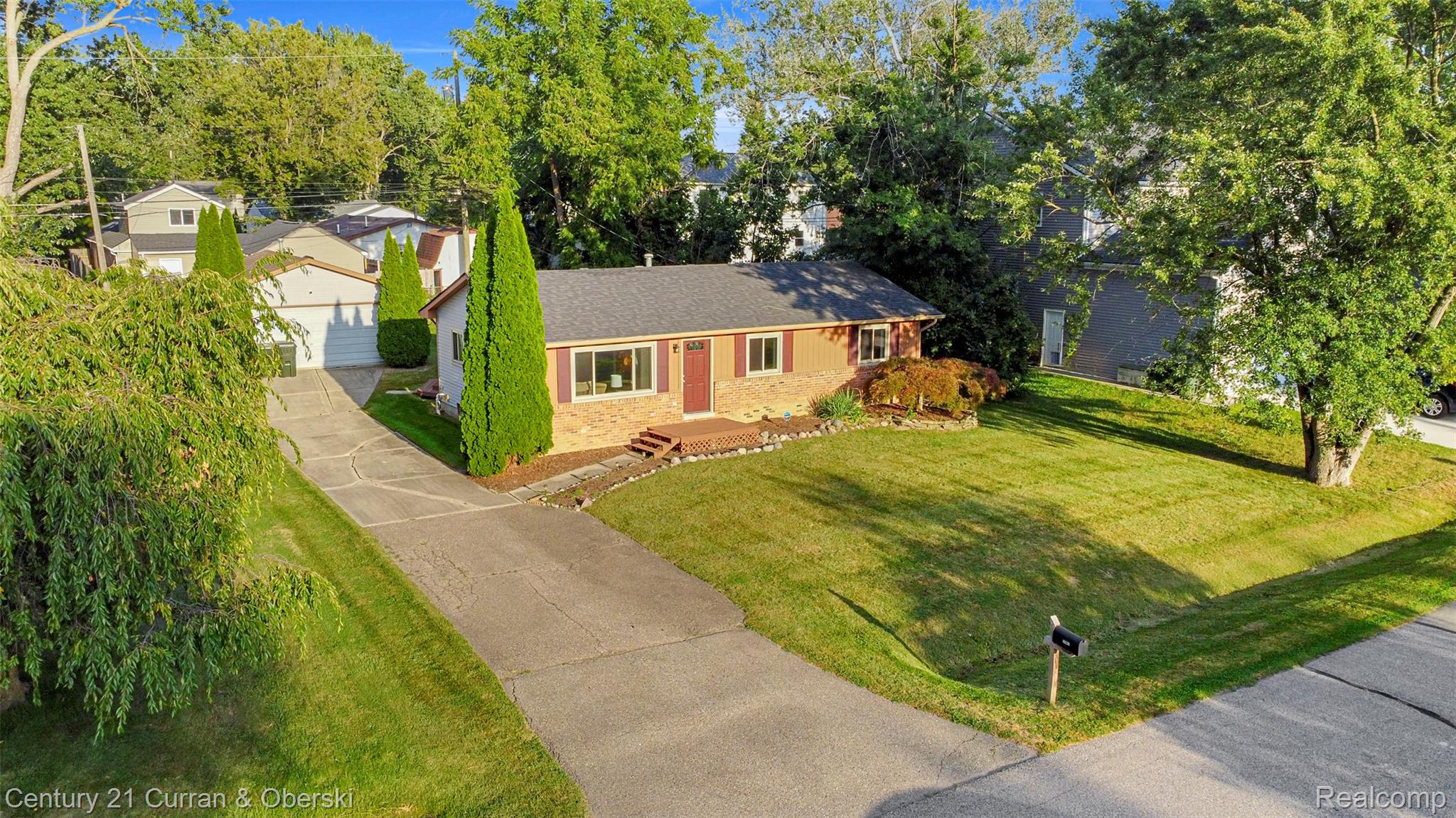 2867 Dearborn Avenue Rochester, MI 48309 - Photo 2 of 25 Ranch-style home featuring a shingled roof, brick siding, a front yard, and an outdoor structure