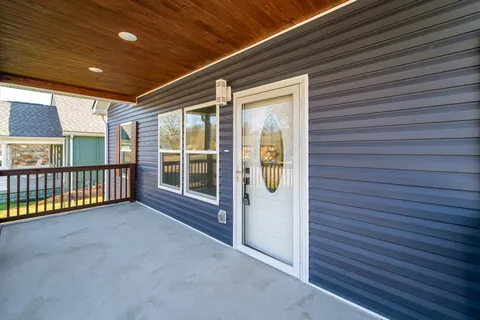 a view of a porch with a table and chairs