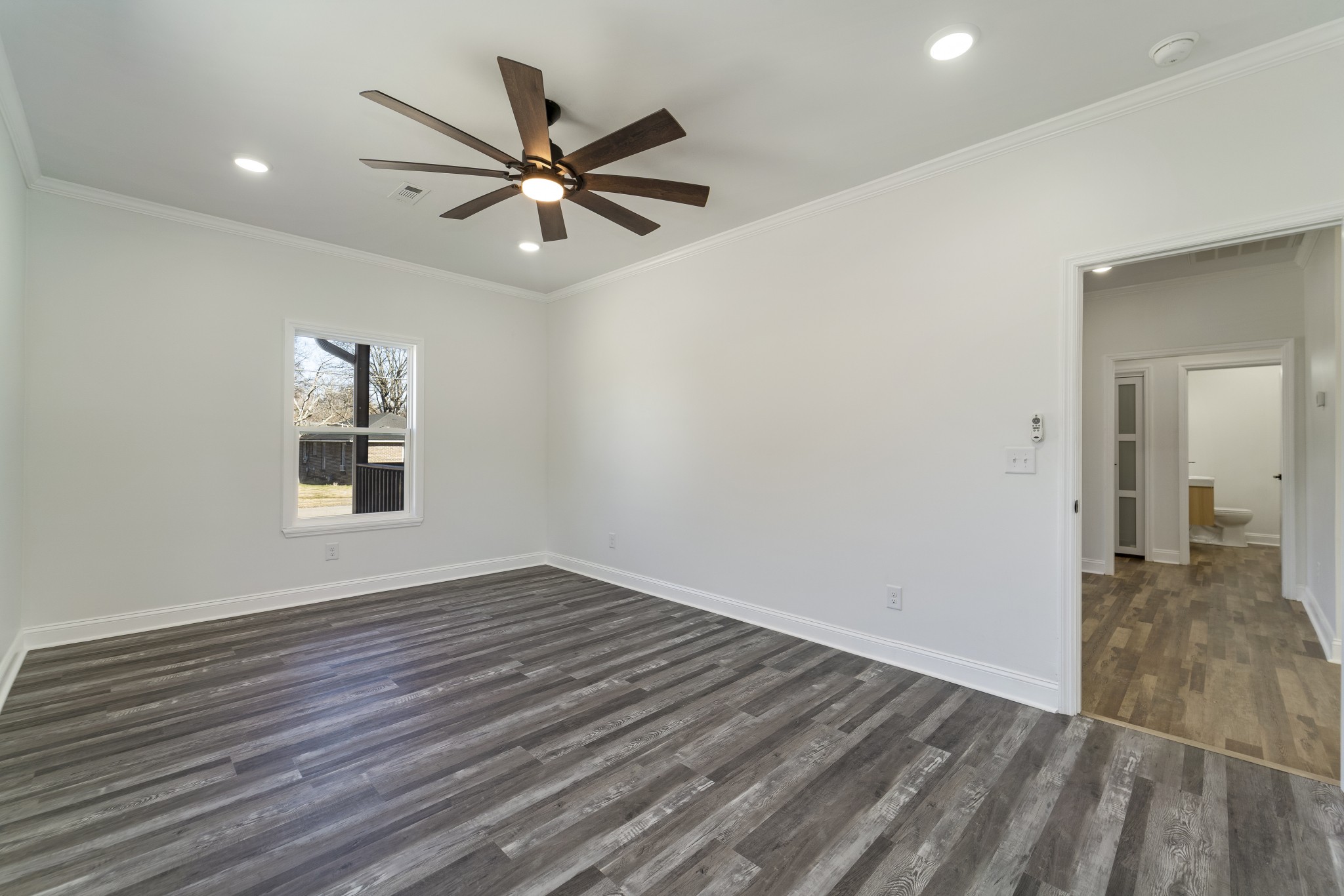 307 Wall Street Mount Pleasant, TN 38474 - Photo 13 of 33 a view of a room with wooden floor and a ceiling fan