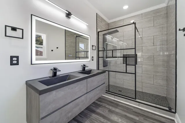 a bathroom with a double vanity sink and mirror