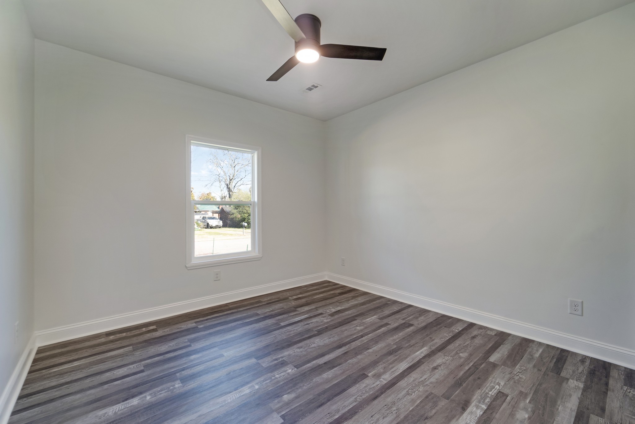 307 Wall Street Mount Pleasant, TN 38474 - Photo 21 of 33 a view of empty room with wooden floor and fan
