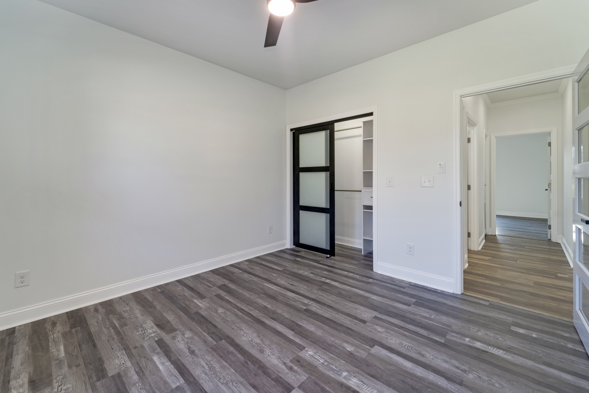 307 Wall Street Mount Pleasant, TN 38474 - Photo 22 of 33 a view of an empty room with wooden floor a ceiling fan