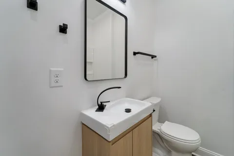a white toilet sitting next to a bathroom sink