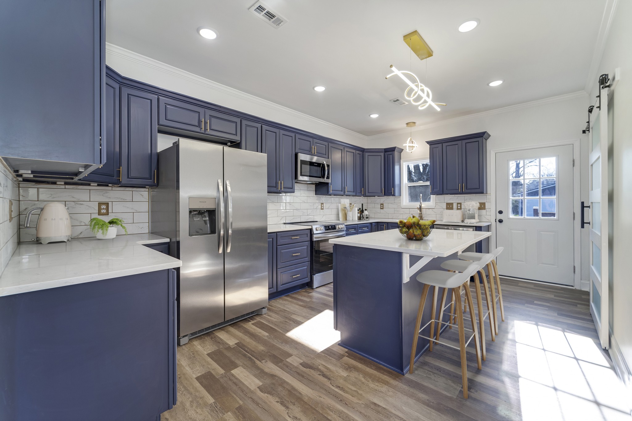 307 Wall Street Mount Pleasant, TN 38474 - Photo 6 of 33 a kitchen with kitchen island a counter top space a refrigerator cabinets a sink and a counter top space