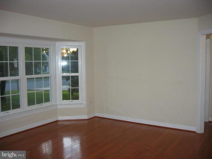 6635 Cornell Drive Alexandria, VA 22307 - Photo 4 of 10 an empty room with wooden floor and windows