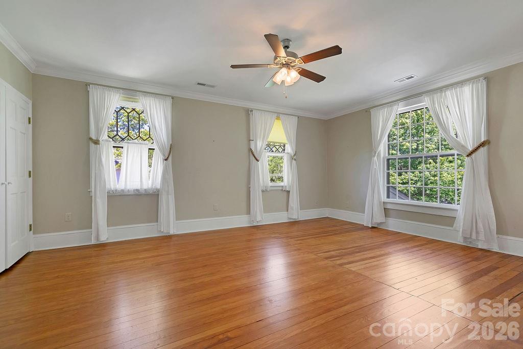 208 West Probart Street Brevard, NC 28712 - Photo 35 of 48 a view of an empty room with window and wooden floor