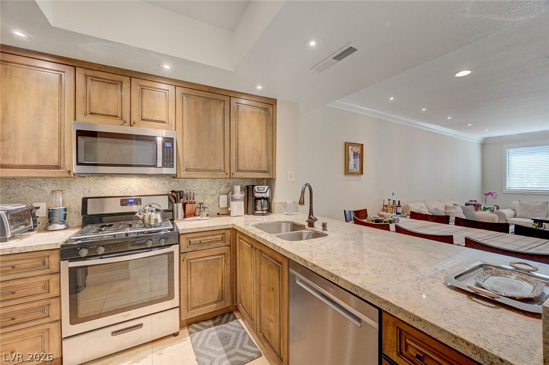 230 East Flamingo Road, Unit 106 Las Vegas, NV 89169 - Photo 9 of 66 Prepare meals in this well-appointed kitchen featuring granite counters and recessed lighting.