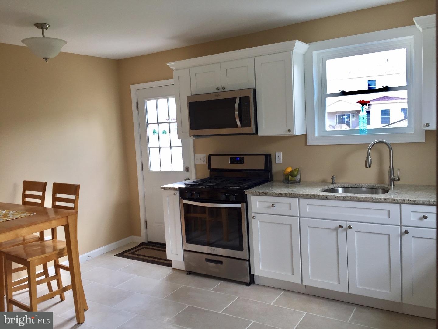 44 Lanci Road Maple Shade, NJ 08052 - Photo 7 of 25 a kitchen with stainless steel appliances granite countertop a stove a sink and a microwave