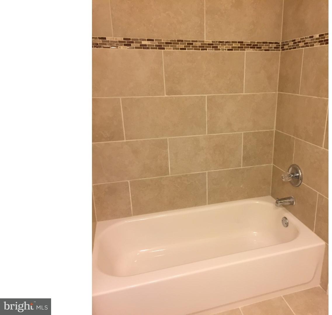 44 Lanci Road Maple Shade, NJ 08052 - Photo 10 of 25 a white bath tub sitting next to a bathroom