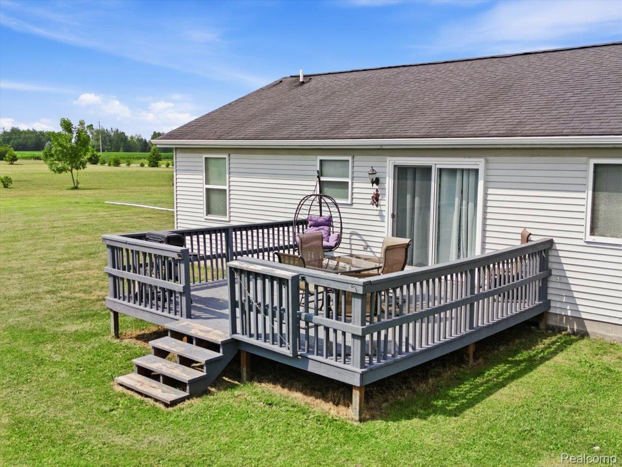 8884 Kilgore Road Avoca, MI 48006 - Photo 21 of 31 Expansive rear deck featuring painted wood construction, full railing, and integrated steps