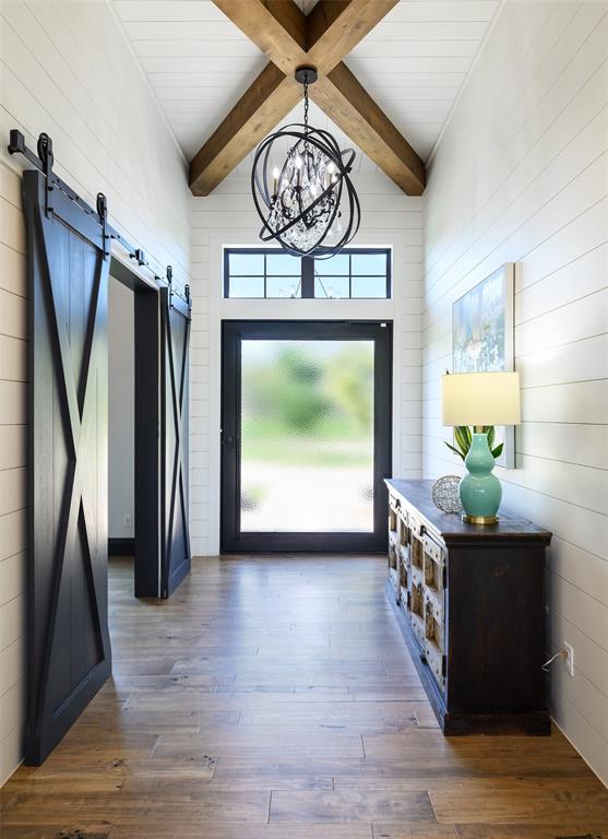 635 Highpoint Road Royse City, TX 75189 - Photo 7 of 35 a view of a hallway with wooden floor and a chandelier