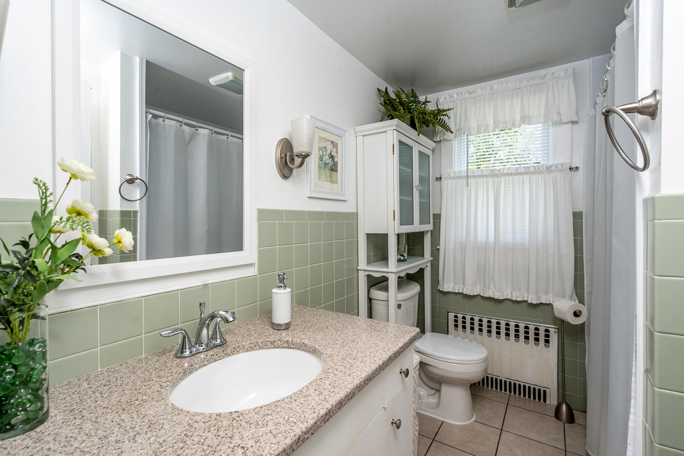 110 Bacon Road Hyannis, MA 02601 - Photo 16 of 37 a bathroom with a granite countertop sink toilet a mirror and shower