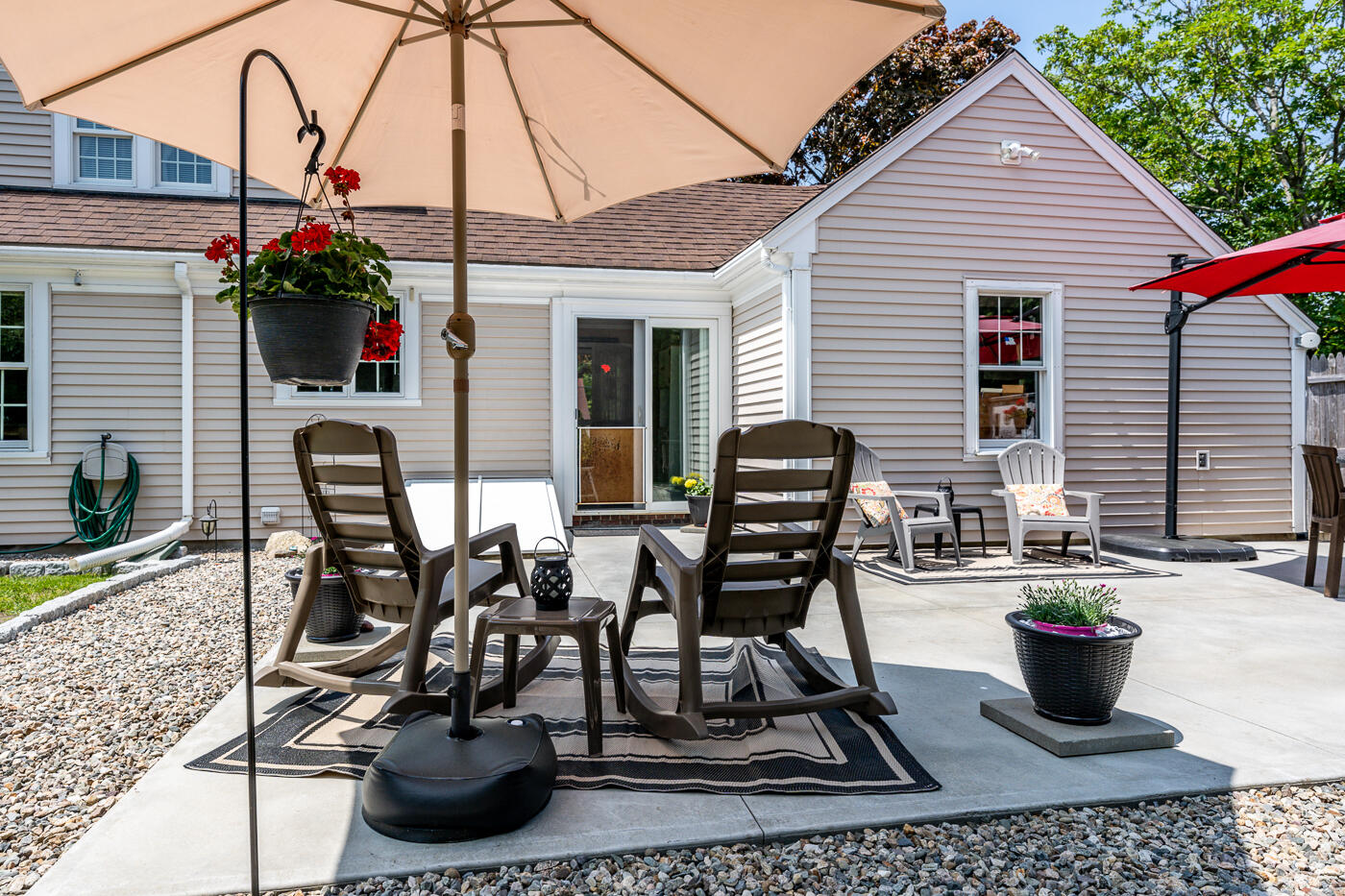 110 Bacon Road Hyannis, MA 02601 - Photo 31 of 37 a view of a chairs and table in the back yard of the house