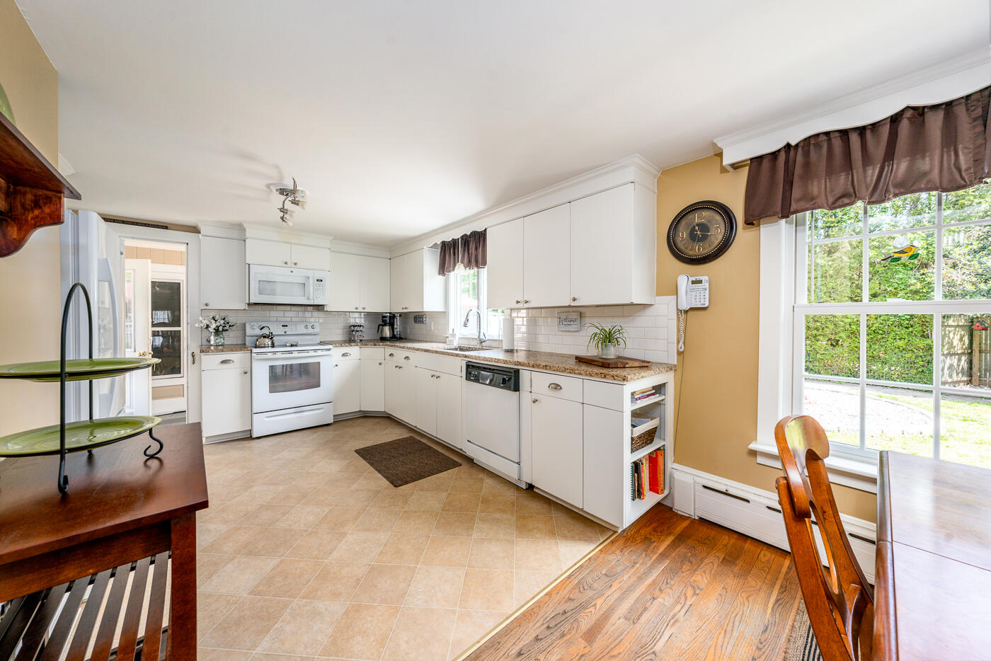 110 Bacon Road Hyannis, MA 02601 - Photo 7 of 37 a kitchen with a refrigerator a stove top oven a sink and a large window