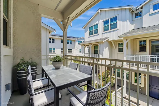 a balcony with table and chairs