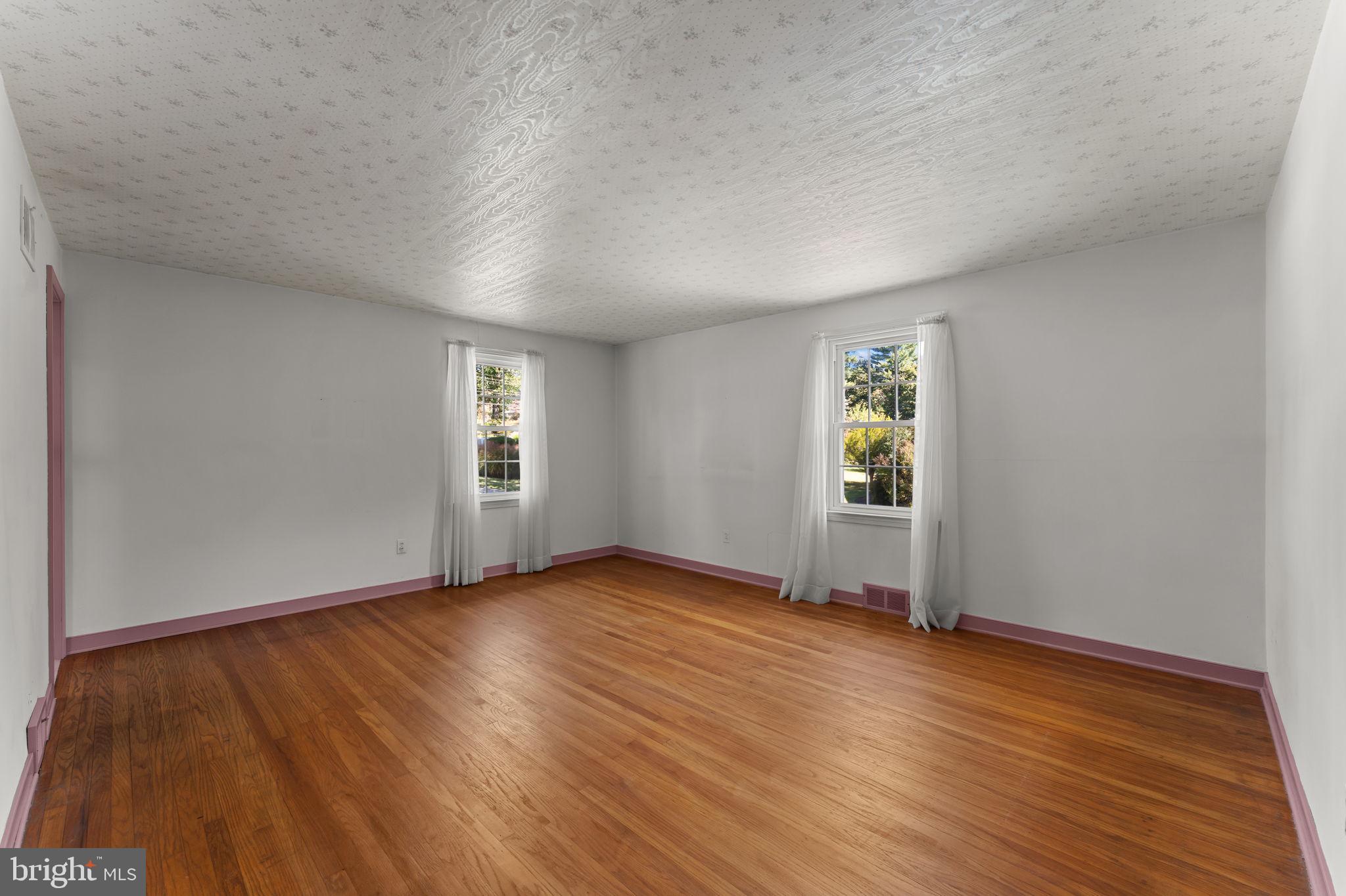 962 Weadley Road Radnor, PA 19087 - Photo 16 of 45 an empty room with wooden floor and windows